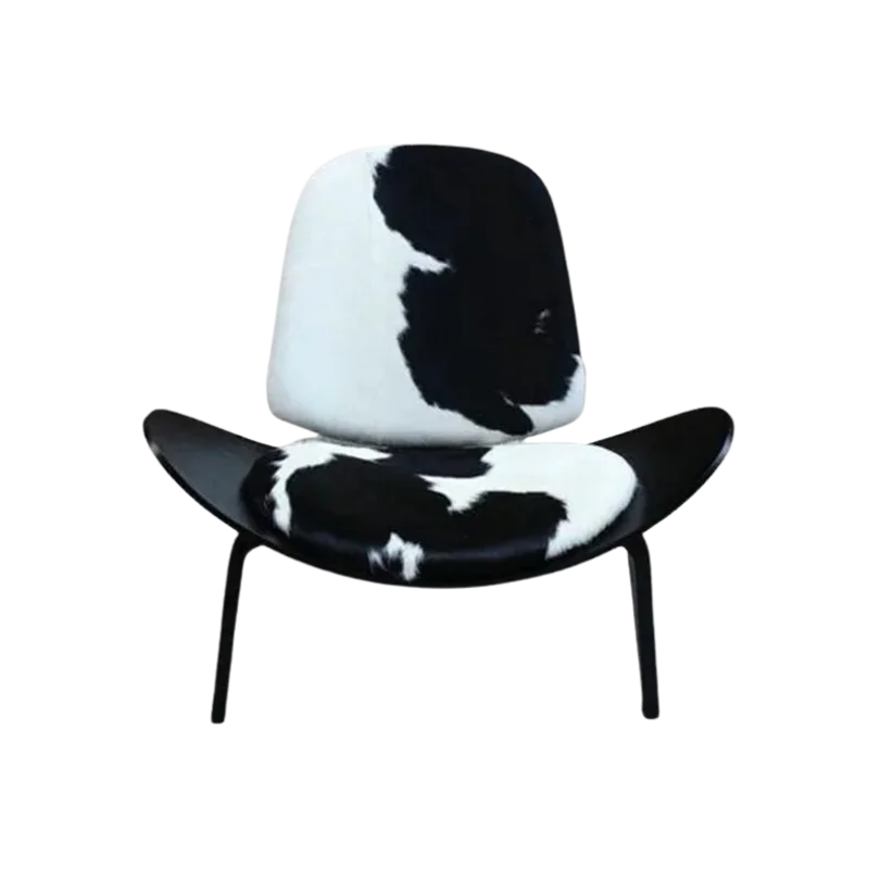 Cowhide Chic Shell Lounge Chair with black and white cowhide upholstery, curved shell seat and sleek modern metal legs