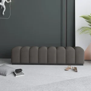 Rectangular flannel upholstered bed bench with scalloped design, placed on a neutral rug in a modern minimalist bedroom setting.