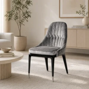Gray velvet tufted chair with black tapered legs in a neutral living room setting