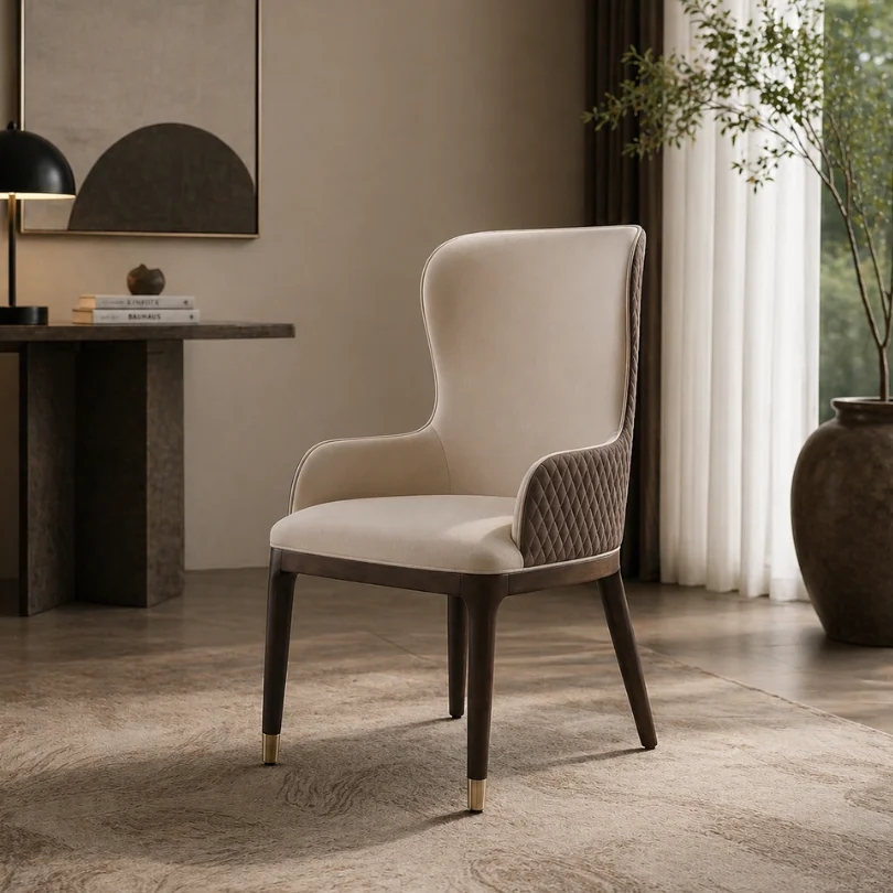Cream upholstered high-back chair with quilted side panels in a modern living room setting
