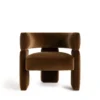 Litho Armchair featuring a sculptural modern design with plush brown upholstery, curved armrests, and a bold contemporary silhouette for luxury interiors