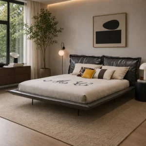 Modern bedroom with a low platform bed, black headboard, and beige bedding with colorful pillows.itting sunlight streams from a large window; a tall plant stands beside the bed.