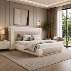 Elegant king bedroom with an upholstered beige headboard, matching nightstands, and a plush gray bedding set in a softly lit room.