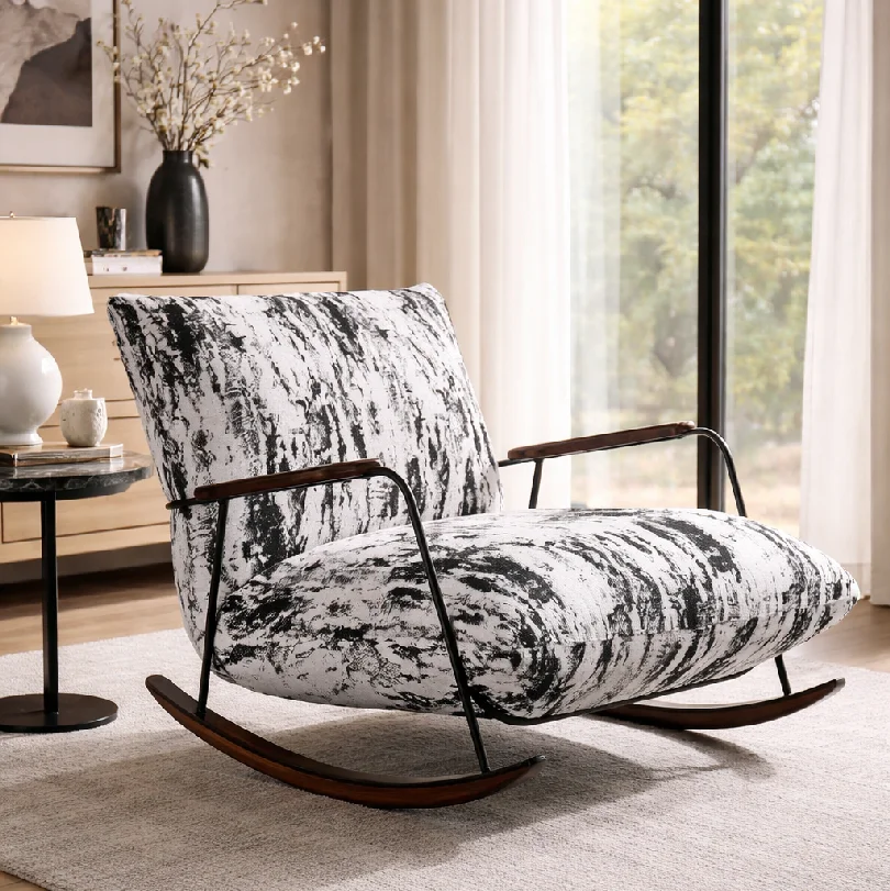 Modern upholstered rocking chair with black-and-white marbled fabric in a bright living room.