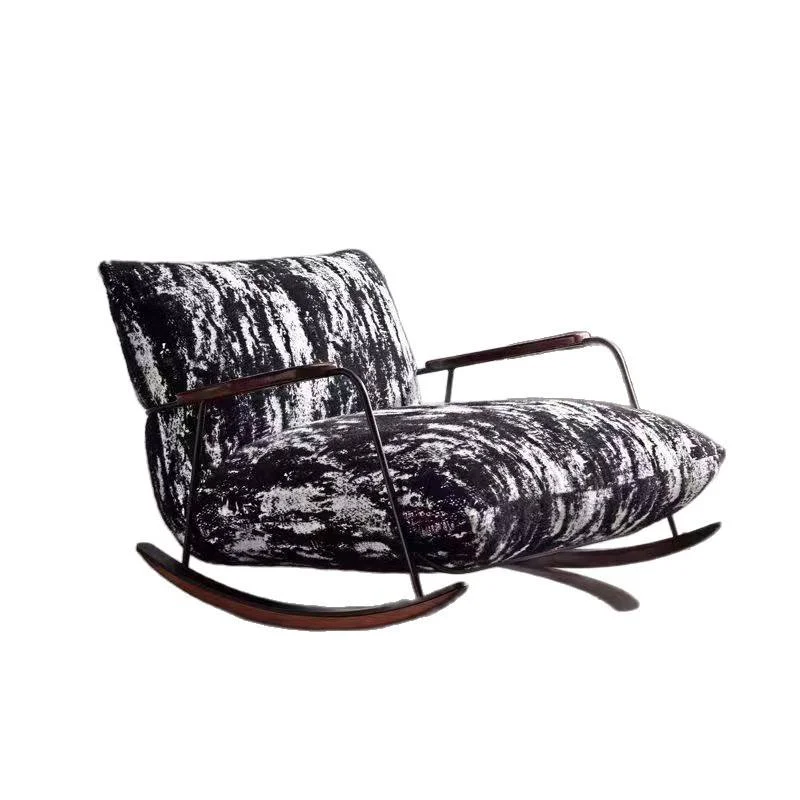 Rocking armchair with black-and-white patterned upholstery and curved wooden rockers.