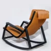 Tan leather lounge chair with a black curved rocking frame, shown reclined to the side.