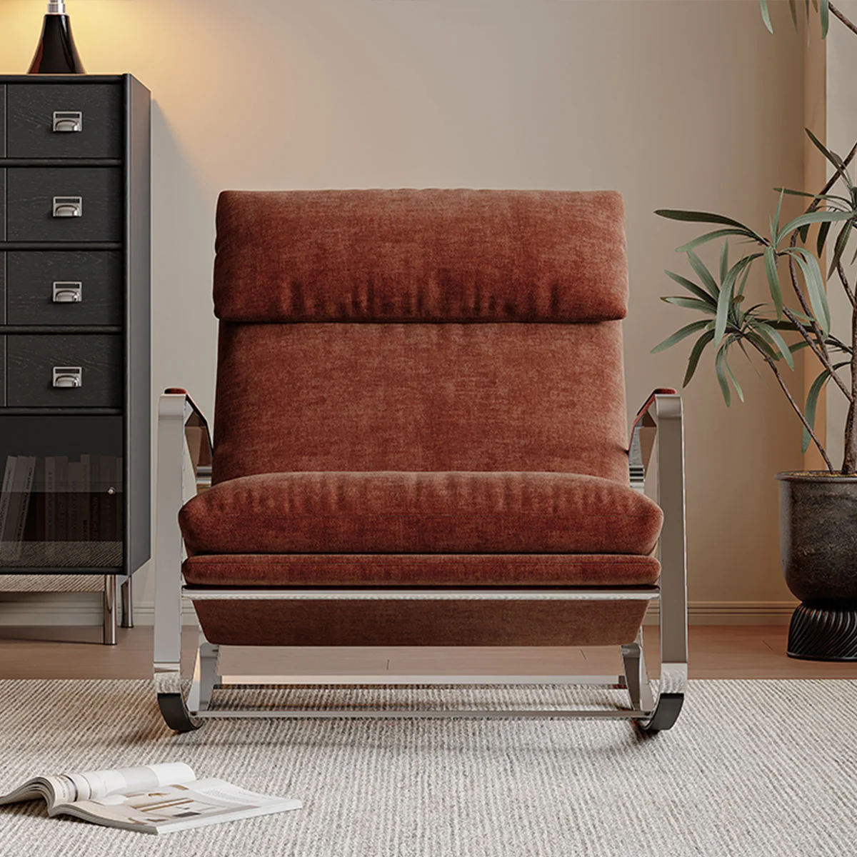 Rust velvet rocking chair in a cozy living room beside a black multi-drawer dresser and a potted plant.