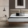 Modern bedroom with low platform bed, beige upholstered headboard, and white bedding with black and gray cushions.