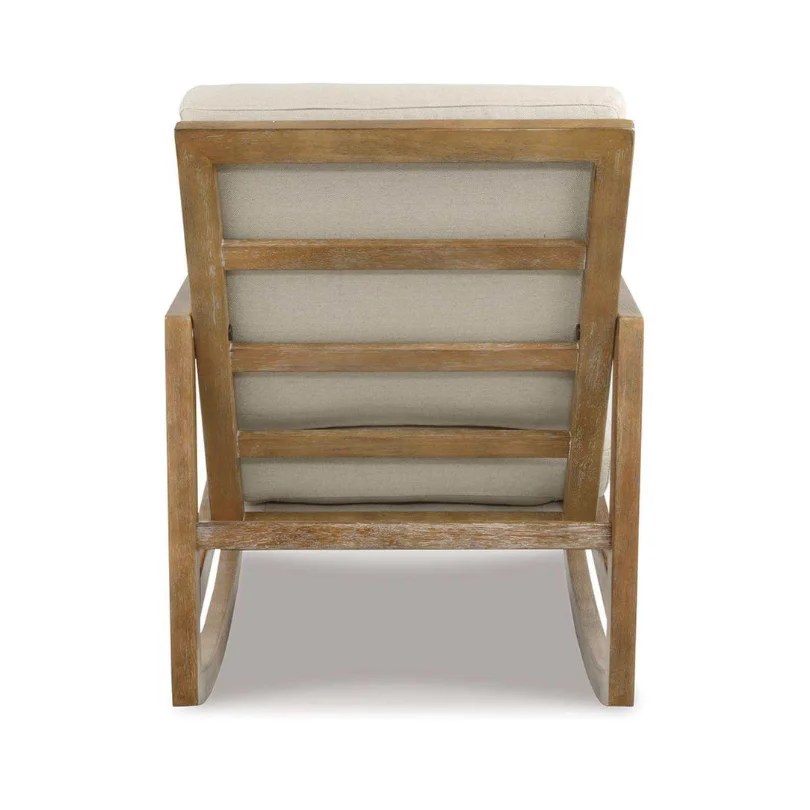 Back view of a wooden armchair with light beige cushions viewed from behind.