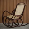 Wooden rocking chair with cane seat and back, curved dark frame, set against vertical wooden panel wall