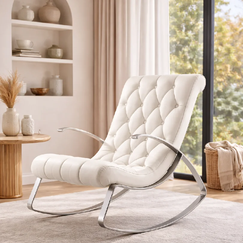 White cushioned lounge chair with tufted back and curved metal frame in a bright living room.