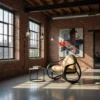 Loft-style room with brick walls, large industrial windows, and a tan curved chair beside a small round table under hanging lights and abstract artwork.