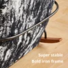 Close-up of a chair showing a bold iron frame and patterned upholstery on a wooden floor, with the caption 'Super stable'.