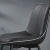 Gray upholstered chair with light piping along seams, close-up profile view.