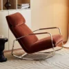 Mid-century orange-brown upholstered lounge chair with a chrome frame in a living room setting.