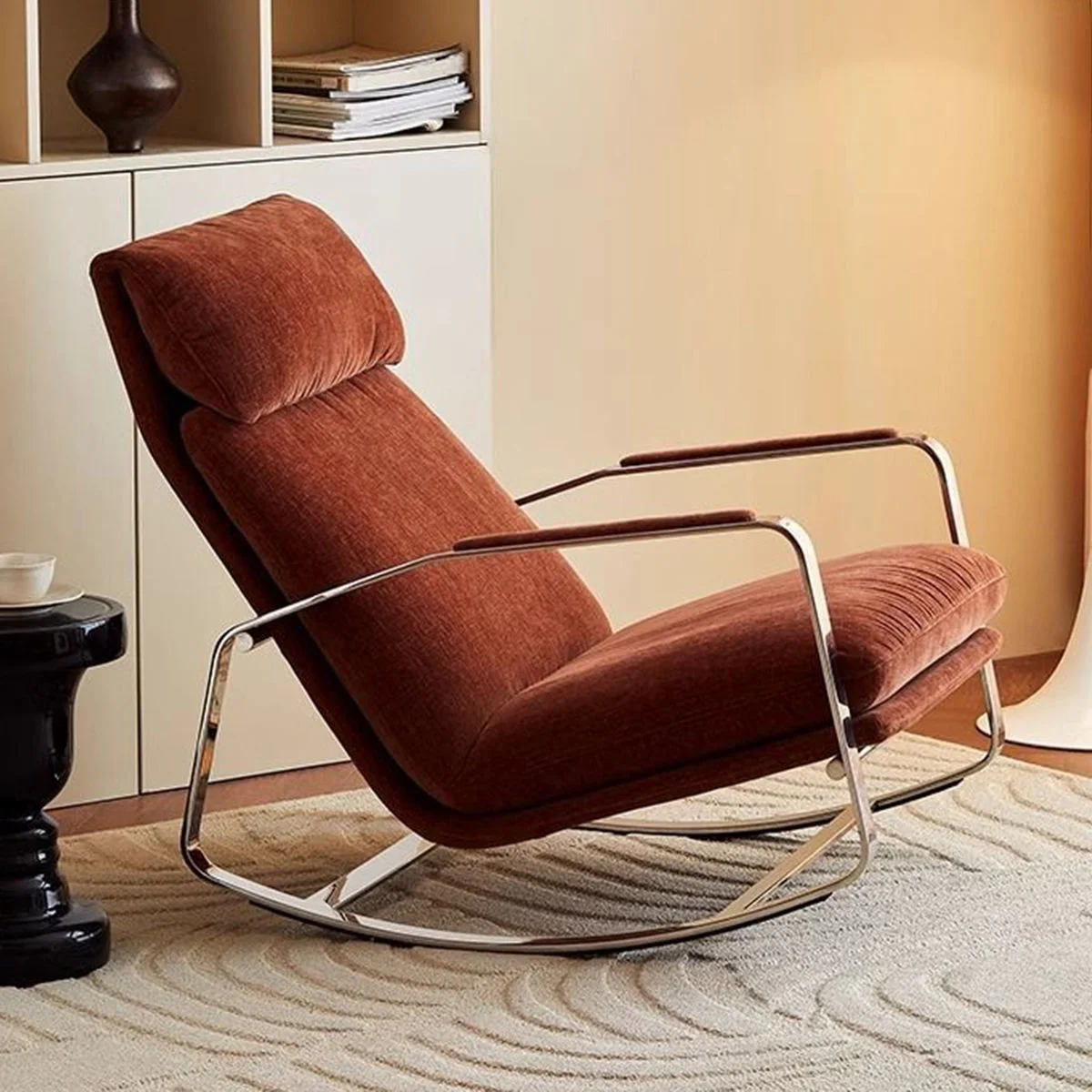 Mid-century orange-brown upholstered lounge chair with a chrome frame in a living room setting.